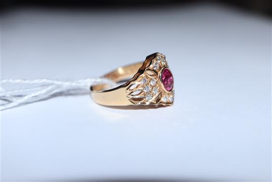 A modern pierced 14ct gold, ruby and diamond hexagonal cluster ring, size N/O.